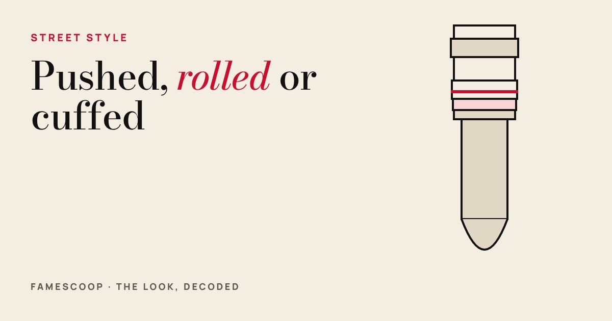 Cream cover with the title in large type and a drawn sleeve with stacked rolled folds and one red cuff line